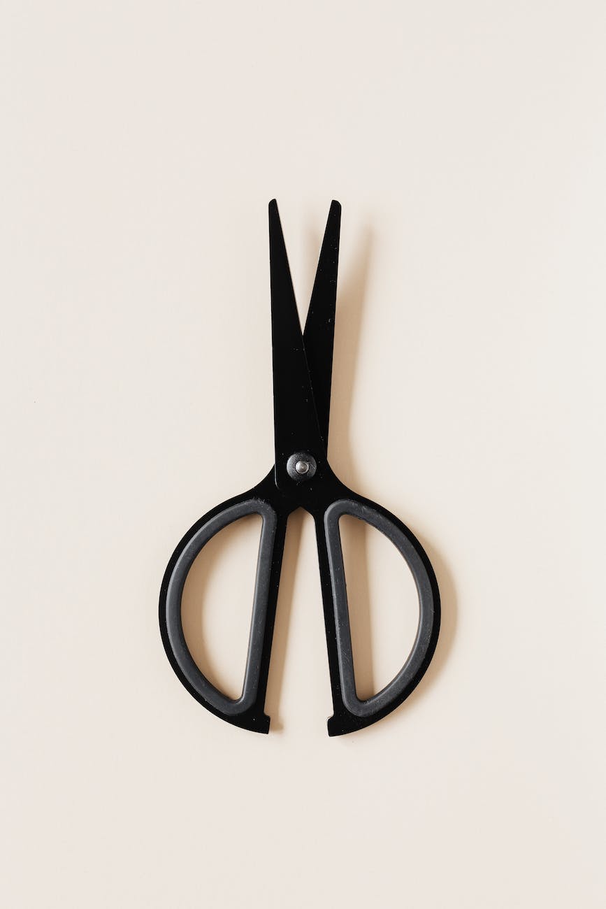 black scissors placed on beige background