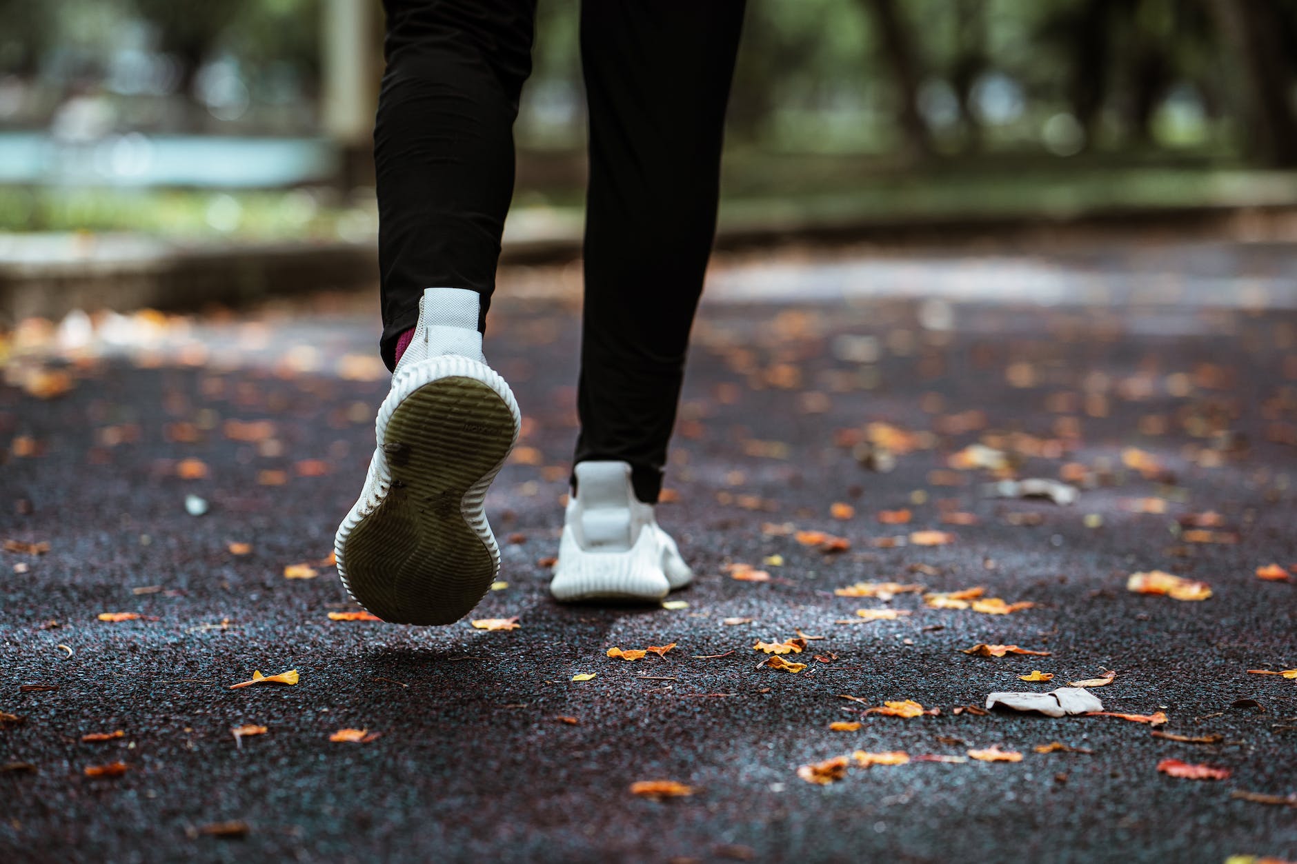 faceless person jogging in empty park