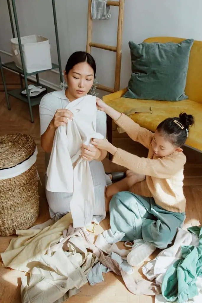 mother organizing clothes with daughter