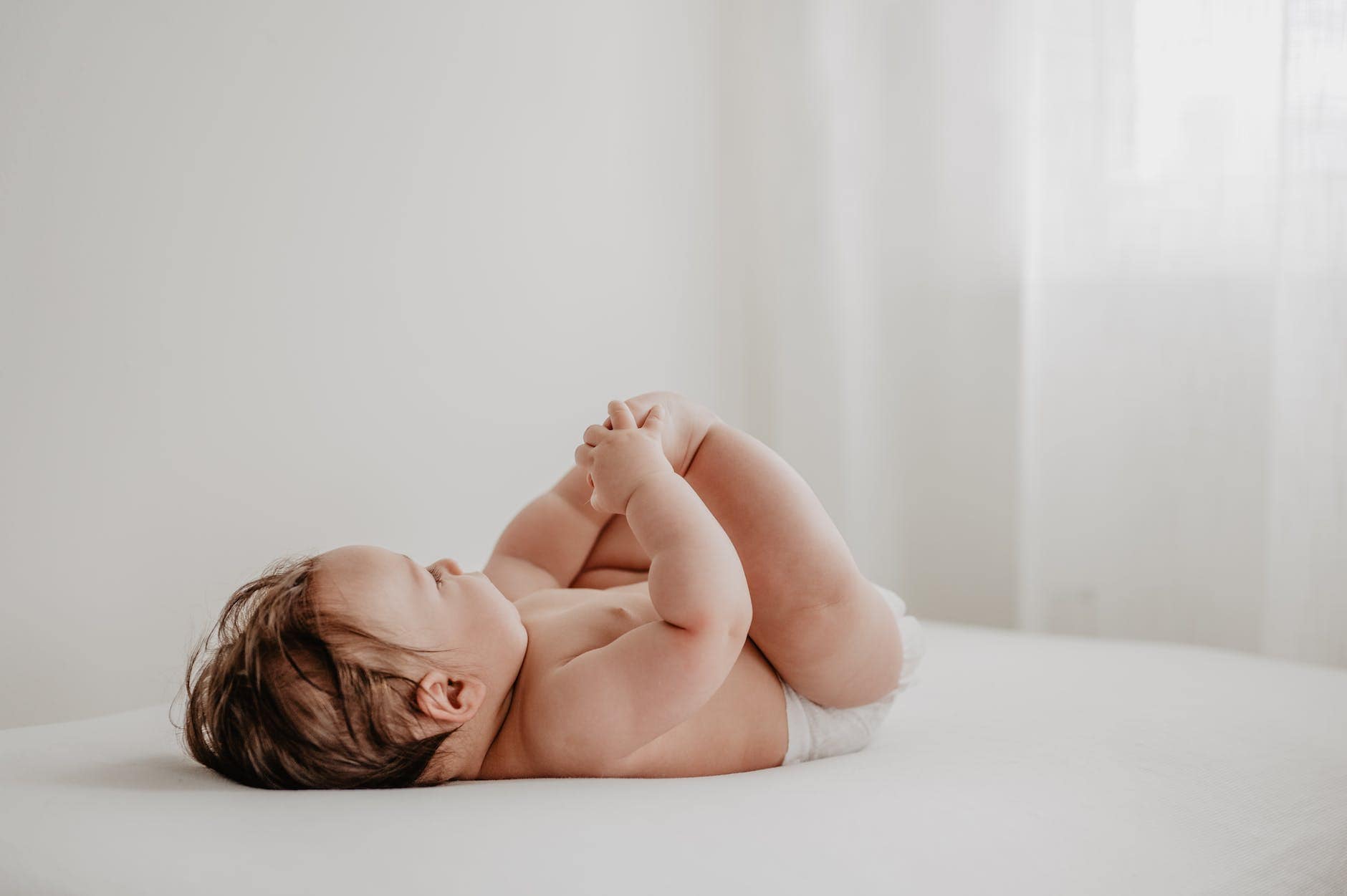 baby lying on bed