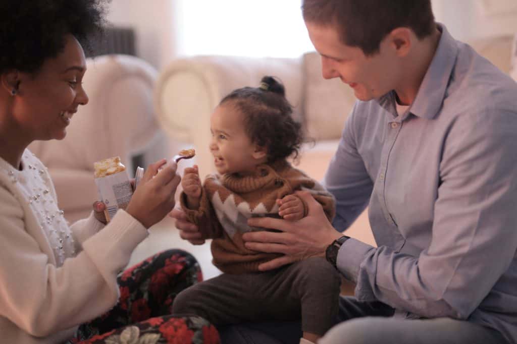 photo of woman feeding her child