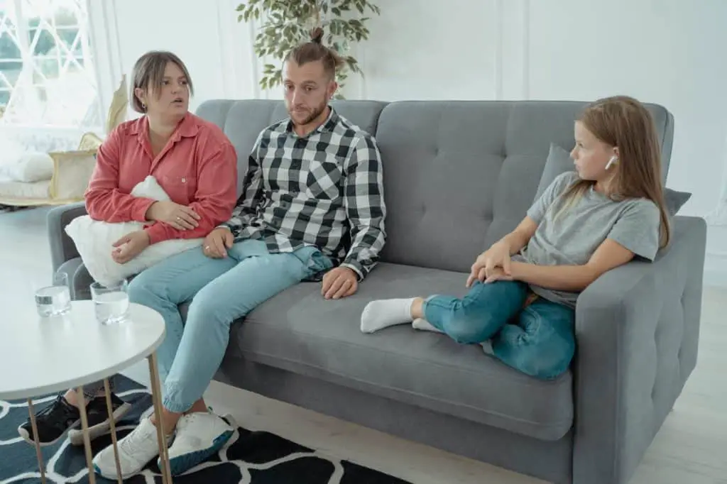 a family sitting on a couch