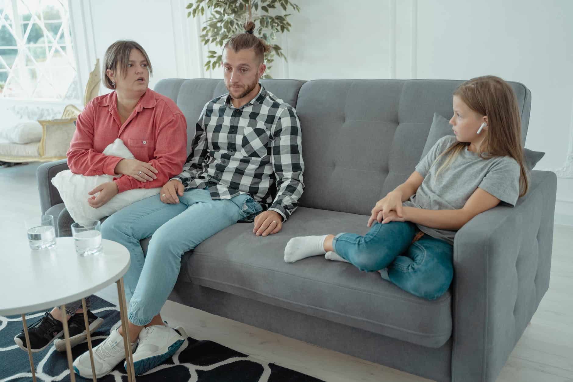 a family sitting on a couch