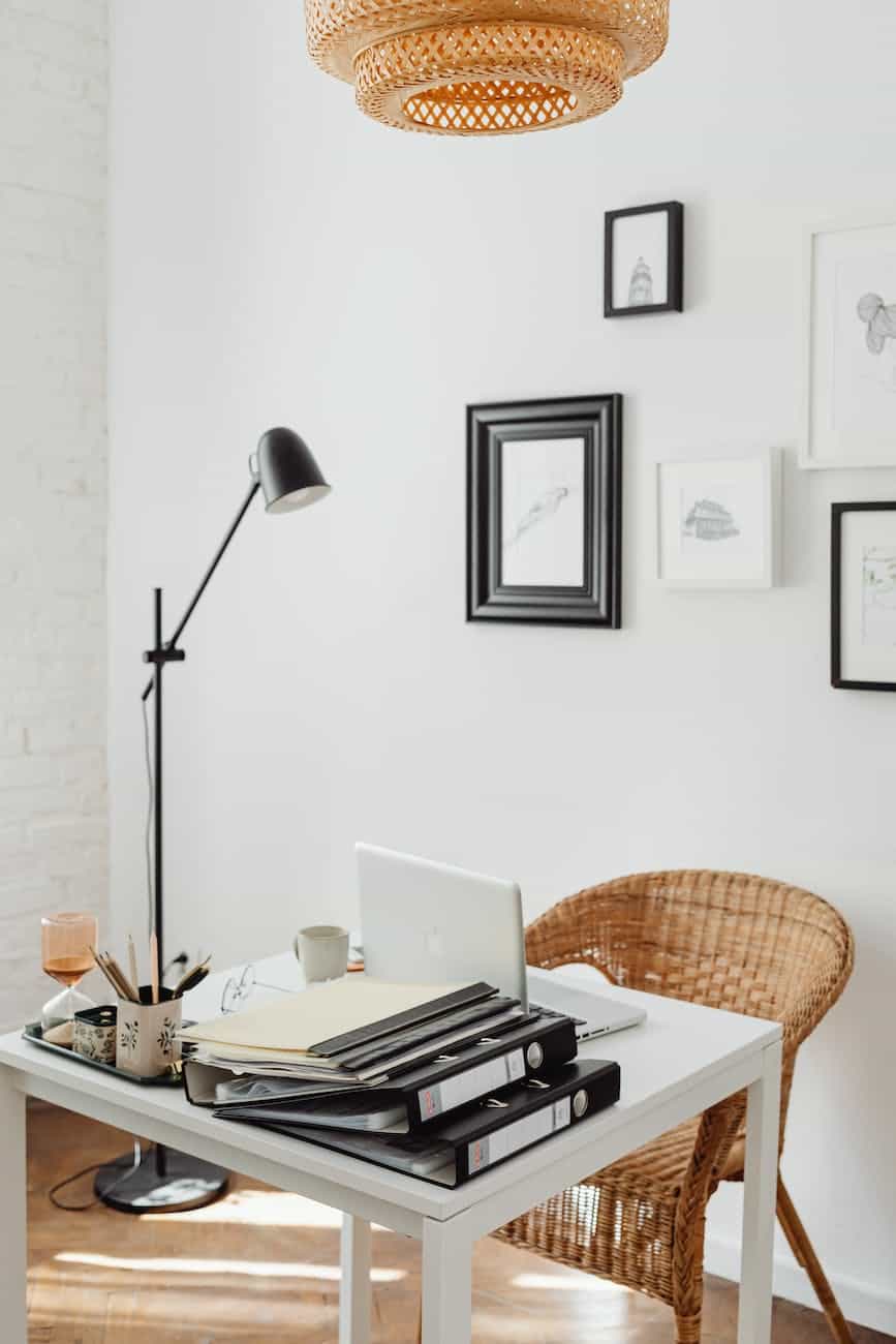 photo of a table with a laptop near a lamp