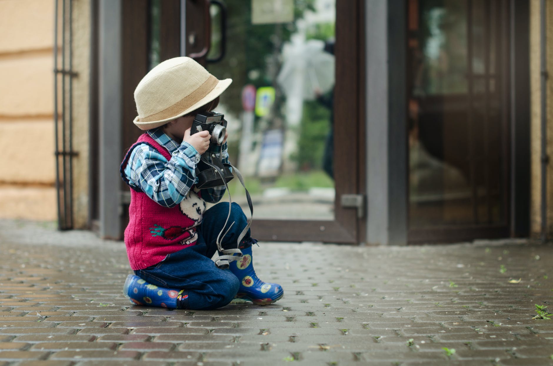 boy taking a photo using camera