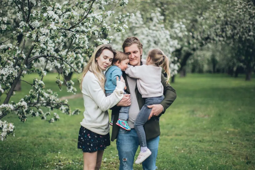 happy family hugging outdoors